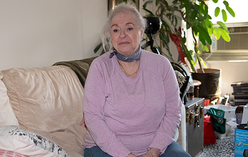 Francine, an elegant older Caucasian woman sitting on her couch. 