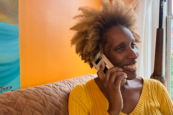 Citymeals volunteer Tracee makes friendly phone calls to her homebound older neighbor. 