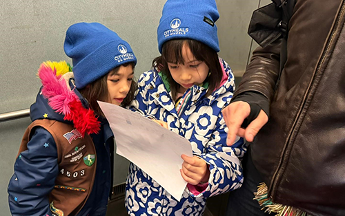 Girl scouts delivering meals to seniors in need in Manhattan