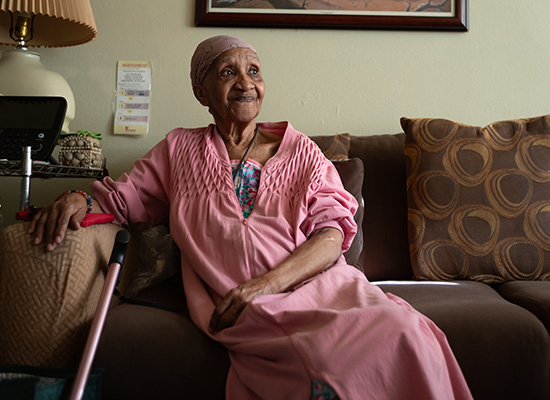 Jewel, a Citymeals recipient with a cane, at home. 