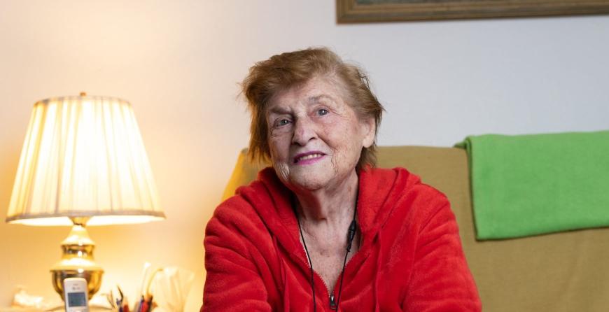 A photo of Dorothy, an older woman in a red sweater. 