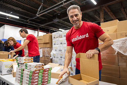 Standard Industries Employees packing meals for homebound seniors with Citymeals on Wheels