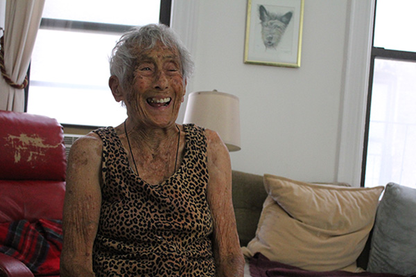 Cozette, an older Asian-American Citymeals on Wheels Recipient in her apartment. 