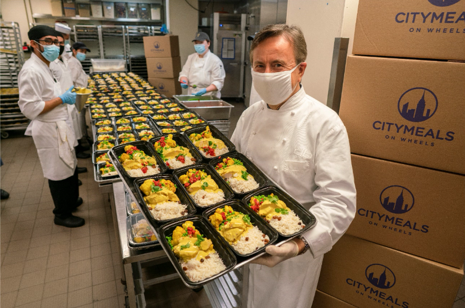 Chef Daniel Boulud, Citymeals Board Co-President, preparing meal for recipients. 